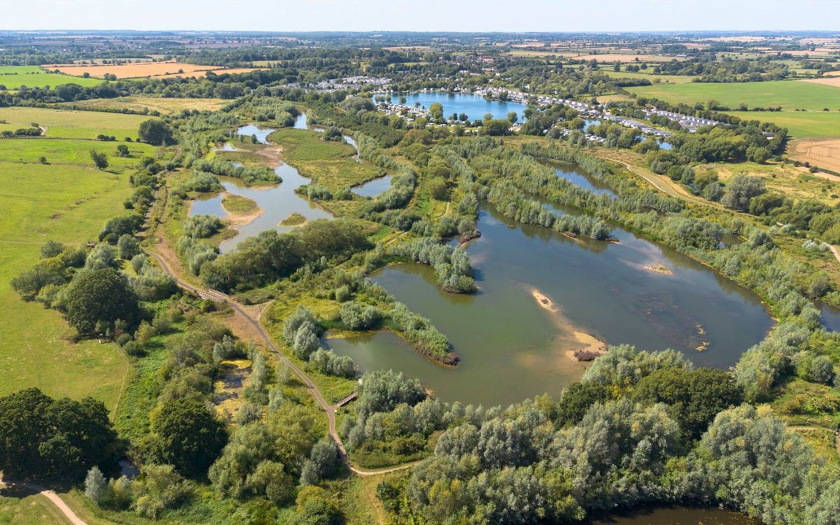 Aerial photo of a wetland nature reserve with lakes surrounded by fields.