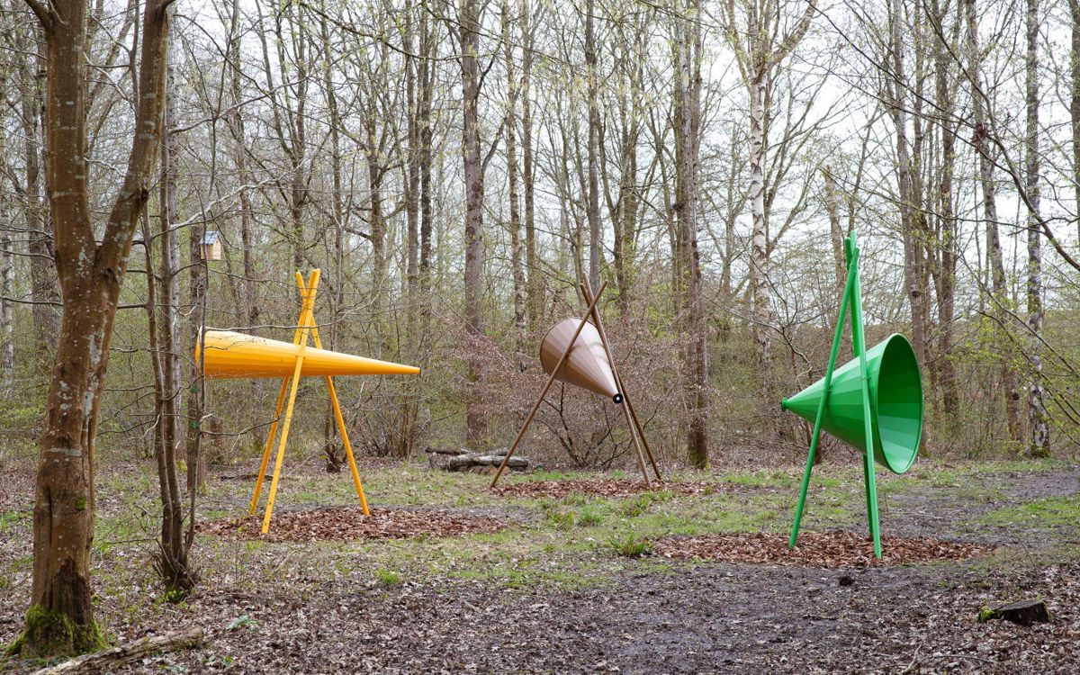 Large yellow, brown and green cones on stands within woodland
