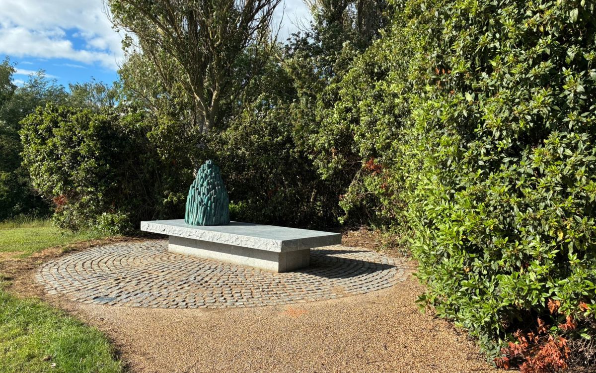 Art sculpture made from bronze, granite and marble on a bench