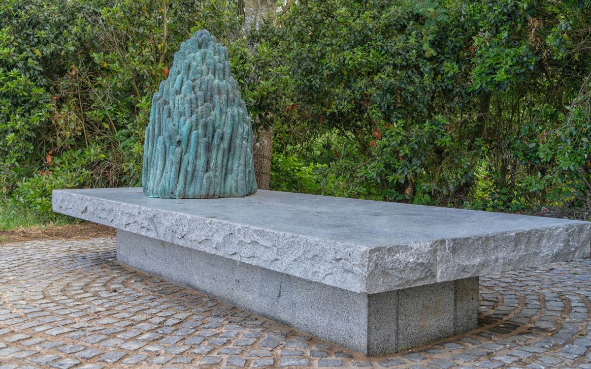 Art sculpture made from bronze, granite and marble on a bench