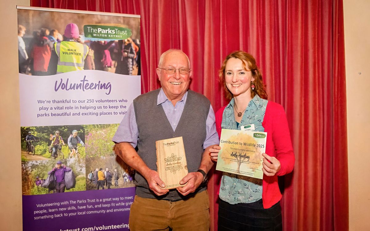 Andy and Sarah holding award and trophy
