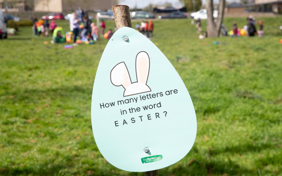 Egg shaped easter trail board sign in park