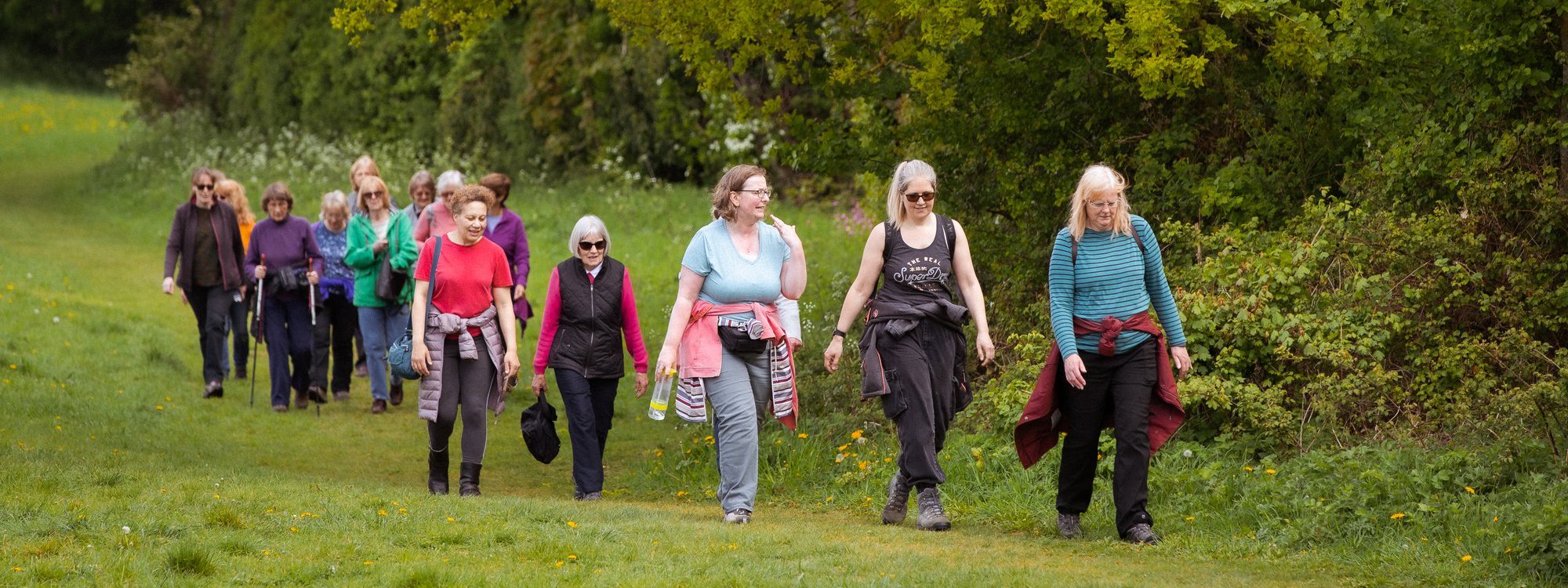 A group of women walking through parkland