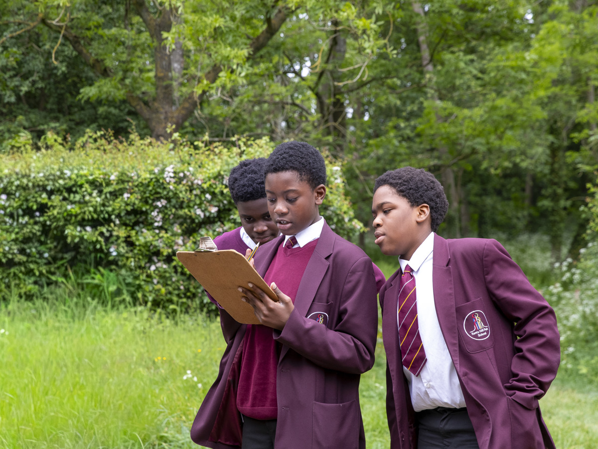 Students looking at notes on a clipboard